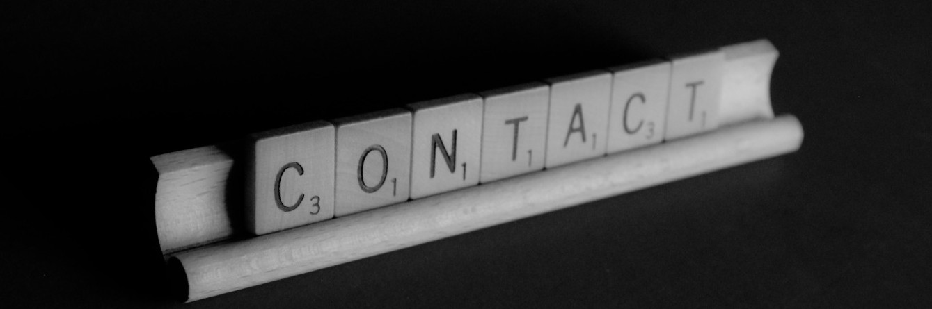 contact spelled out in scrabble tiles